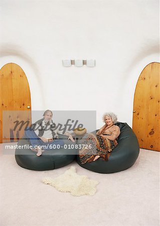 Couple Sitting in Bean Bag Chairs in Living Room