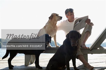 Man on Dock with Dogs, Three Mile Lake, Muskoka, Ontario, Canada