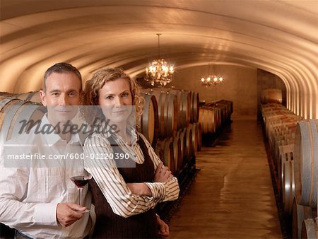 Couple Standing in Wine Cellar