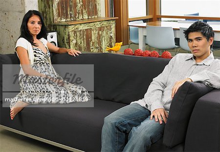 Couple Sitting on Sofa at Home