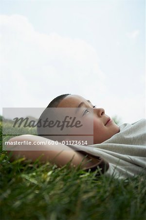 Boy Lying Down on Grass