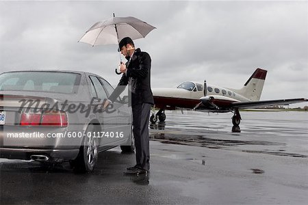 Man Opening Car Door on Airport Tarmac