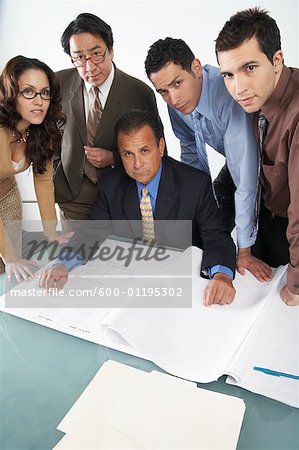 Business People Looking at Blueprints