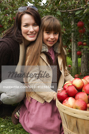 Mother and Daughter in Apple Orchard