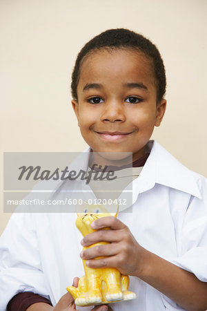 Portrait of Boy Holding Sculpture