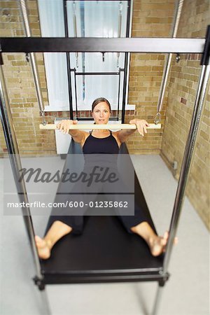 Woman on Pilates Exercise Machine