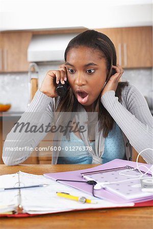 Girl with Homework Talking on Phone