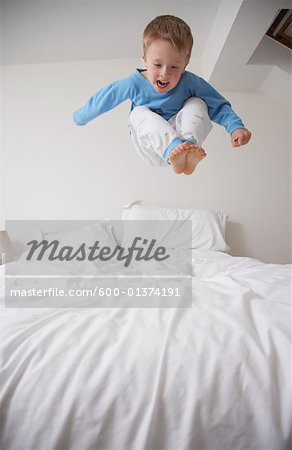 Boy Jumping on Bed