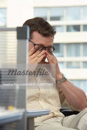 Businessman Rubbing Eyes