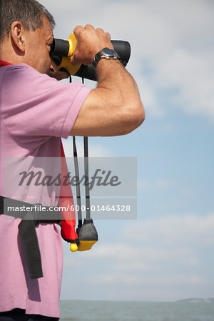 Man Looking Through Binoculars