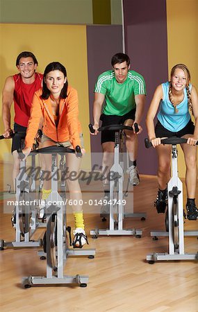 Group of People Using Exercise Bicycles