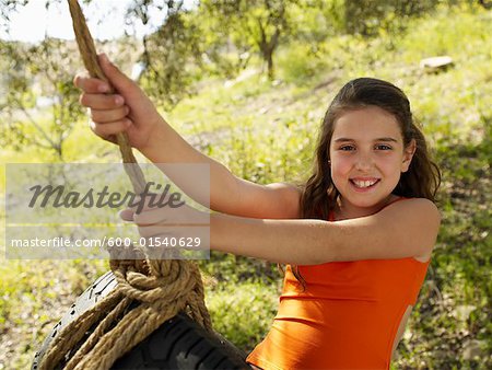 Girl Swinging on Tire Swing
