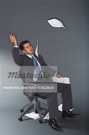 Frustrated Businessman Throwing Documents in Air