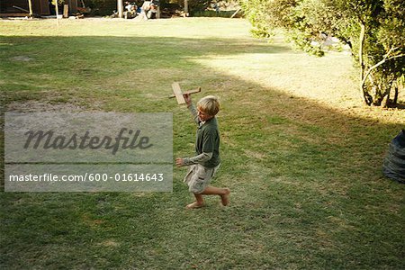 Boy Playing With Toy Airplane