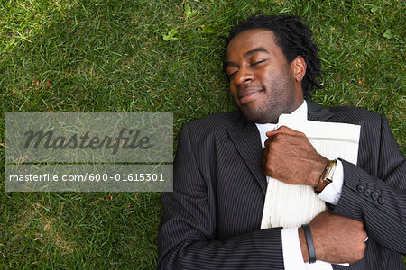 Businessman Lying in the Grass