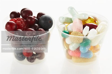 Berries and Pills in Medicine Cups