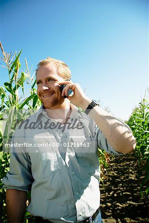 Farmer in Cornfield with Electronic Organizer