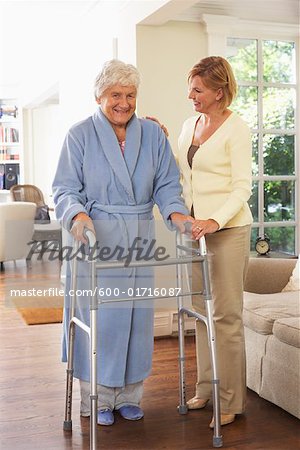 Senior Woman Receiving Assistance with Using Walker
