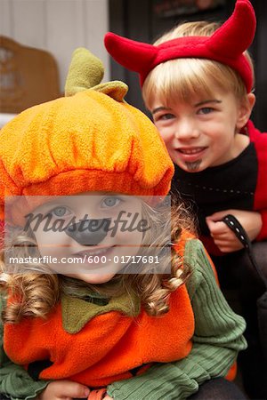 Portrait of Girl Dressed-up as Pumpkin and Boy Dressed-up as Devil