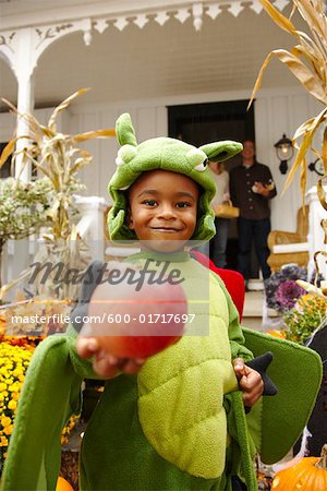 Portrait of Boy Holding Apple and Trick or Treating at Halloween