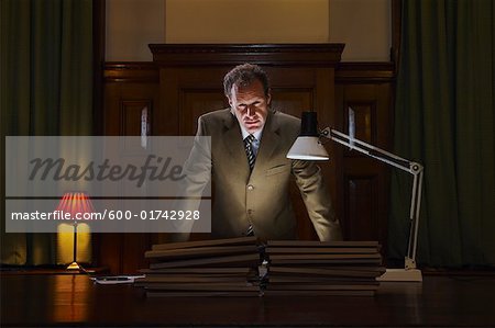 Businessman Leaning over Boardroom Table