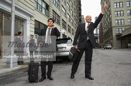 Businessmen Hailing Taxi, New York City, New York, USA