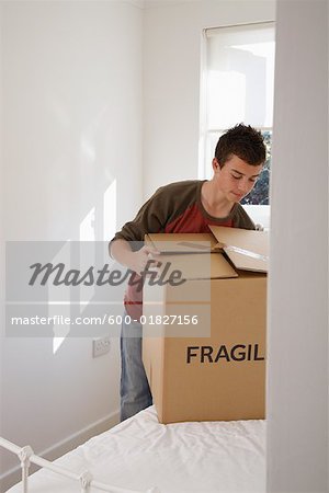Boy with Cardboard Box in Room