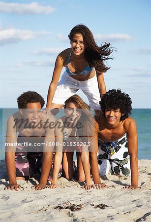 Friends in Human Pyramid on Beach
