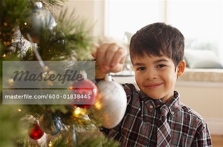 Boy Decorating Christmas Tree