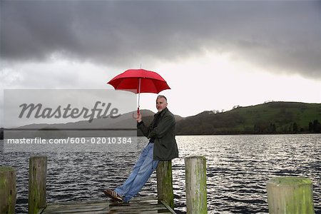 Man on Dock in Rain, Windermere, Cumbria, England