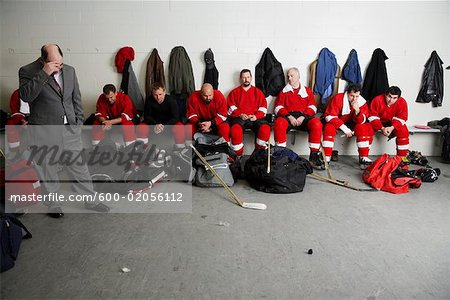 Coach and Hockey Players in Dressing Room