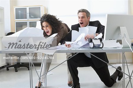 Business People Trying To Hold Onto Paperwork Blowing Around On