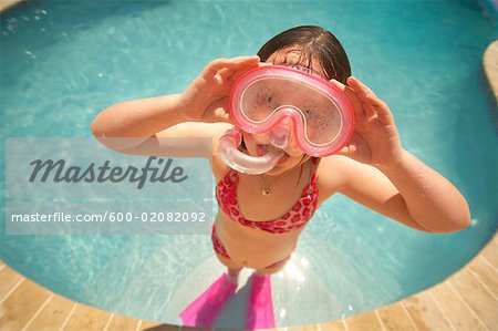 Girl Wearing Snorkel and Goggles in Swimming Pool