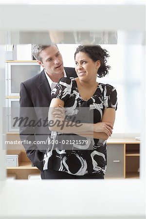 Businessman Flirting with Businesswoman in Office