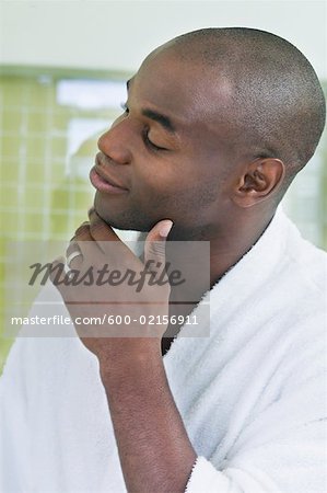 Man Admiring Self in Bathroom Mirror