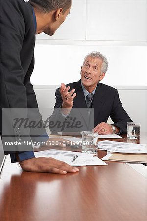 Businessmen Talking in Boardroom