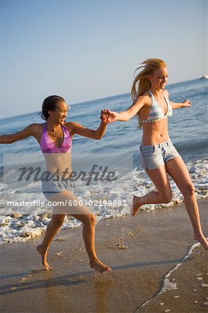 Two Teenage Girl Running on Beach