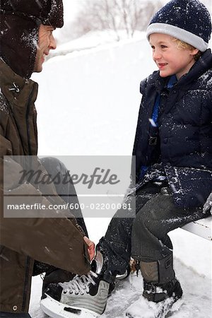 Father Helping Son Put on Skates