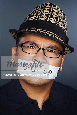 Tape With Shut Up Written on it Covering Man's Mouth