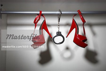 Still Life of Red Shoes and Handcuffs in Closet