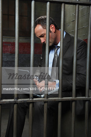 Man Using Laptop in Jail