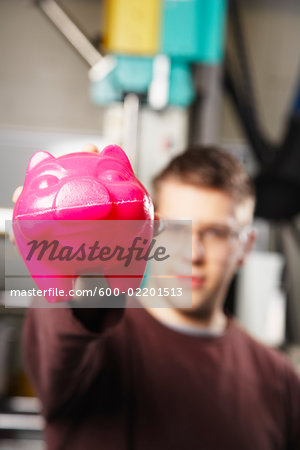 Man Holding Molded Plastic Pig