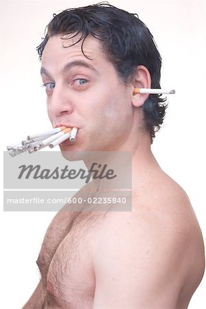 https://image1.masterfile.com/getImage/600-02235840em-man-smoking-many-cigarettes-stock-photo.jpg