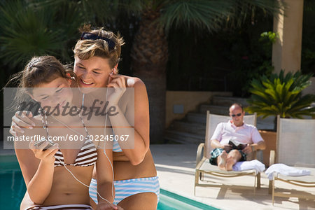 Mother and Daughter by Swimming Pool, Listening to Music Mother and Daughter by Swimming Pool, Listening to Music