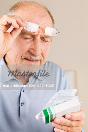 Man Reading Instructions for Medicine