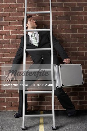 Businessman Walking Under Ladder