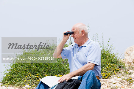 Man Hiking, Looking Through Binoculars