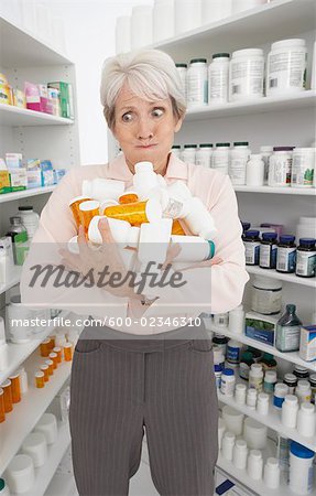 Woman Holding Pill Bottles