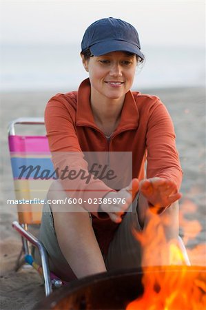 Woman Sitting by a Campfire, Santa Cruz, California, USA