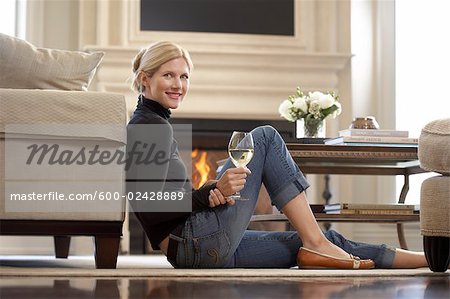 Woman with Glass of Wine in Living Room